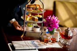a three tiered tray of food on a table at Yiwu Ocean Hotel - Original Best Western Premier Ocean Hotel in Yiwu
