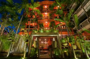 a building with a bunch of plants on it at Golden Butterfly Villa in Siem Reap