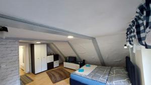 a bedroom with a bed in a attic at Słoneczny apartament in Duszniki Zdrój
