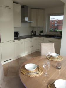 eine Küche mit einem Holztisch mit zwei Schüsseln darauf in der Unterkunft Auszeit am Fähranleger in Grünendeich + 17 Fotos