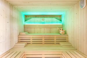 a sauna with a wooden floor and a bluevisorermott at Casas Pepe Apartments & Spa- Adults Only in Playa del Ingles