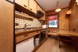 a kitchen with wooden cabinets and a sink at Aktivurlaub Morandell in Sölden