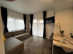 ein kleines Wohnzimmer mit einem Sofa und einem Tisch in der Unterkunft La Molinalda in Castelnuovo del Garda