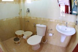 a bathroom with a toilet and a sink at Phils' Residency & Banquets in Cochin