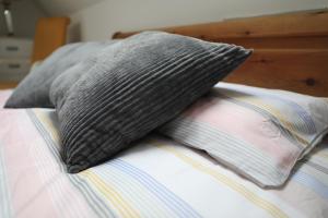 a pillow sitting on top of a bed at Cosy Loft situated on shores of Lough Neagh 