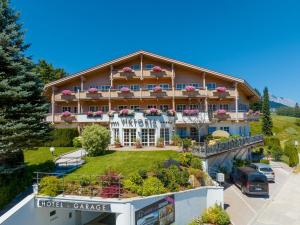 a hotel in the mountains with cars parked in front of it at A-VITA Viktoria & A-VITA living luxury apartments in Seefeld in Tirol