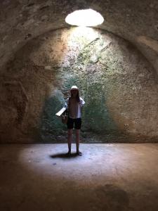 a woman standing in a tunnel with a light at STARBAL in Es Castell