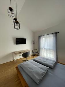 a bedroom with a bed and a desk and a television at BNB Klinga in Klinga
