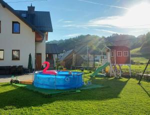 a playground with a plastic toy swan in the yard at Pokoje Czajka- Agroturystyka in Ochotnica Górna