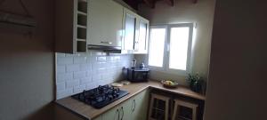 a small kitchen with a stove and a window at Ático El Marquito in Santa Cruz de la Palma +17 photos