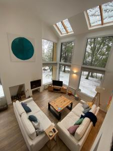 a living room with two couches and a table at Casa del Bosque in San Carlos de Bariloche