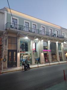 a building with a motorcycle parked on the side of the street at TheJoy Residence Apartments in Chania Town