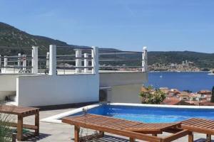 a swimming pool on the roof of a house at Vis - luxury holiday villa with swimming pool in Vis