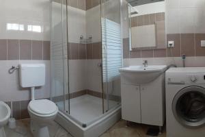 a bathroom with a shower toilet and a sink at Vis - luxury holiday villa with swimming pool in Vis +11 photos
