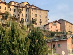 a building on the side of a hill with houses at Apartment Casa Dono Il lago in Pognana Lario