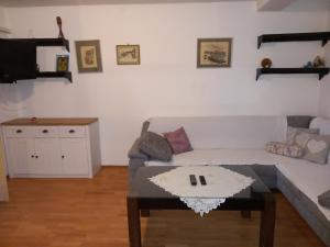 a living room with a couch and a coffee table at Apartments Kurilj in Makarska