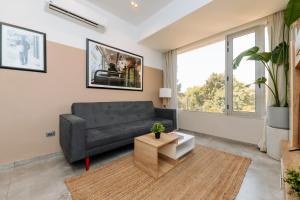 a living room with a couch and a table at Brassbell apartments in Zamalek in Cairo