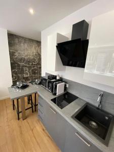 a kitchen with a counter with a sink and a microwave at [Udine Centro] Ade Apartment in Udine