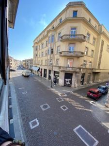 a street with cars parked in front of a building at [Udine Centro] Ade Apartment in Udine