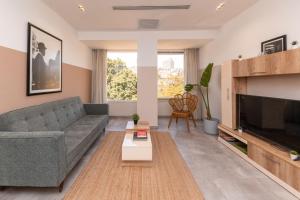 a living room with a couch and a tv at Brassbell apartments in Zamalek in Cairo