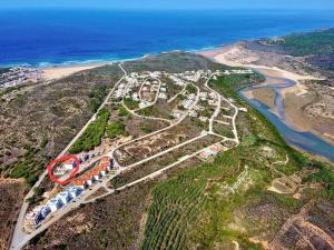 an aerial view of a bridge on a mountain next to the ocean at Beach House - Casa de Férias MONTE CLÉRIGO in Aljezur