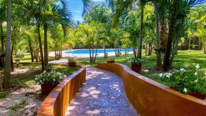 a wooden fence next to a swimming pool with palm trees at King Oasis, Private Pool, BreathtakingGardens, Car in Nassau