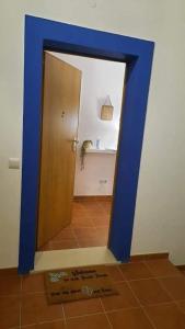 a mirror with a blue frame in a bathroom at Beach House - Casa de Férias MONTE CLÉRIGO in Aljezur
