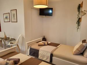a bedroom with a bed and a chair and a tv at Sobe Pilajevo 2, 183 Ulica Stjepana Radića, Gola in Gola