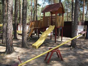 a playground with a yellow slide and a tower at RS Dobrota in Staré Splavy