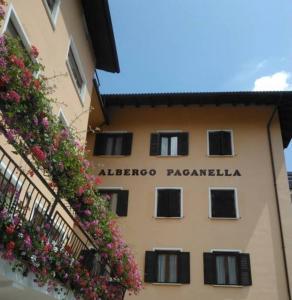 a building with a window and a balcony at Hotel Paganella in Molveno