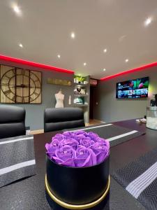ブザンソンにあるATELIER DES REVES - au coeur de Besancon - 88 m2の紫色の大きなバラの花束が飾られた部屋