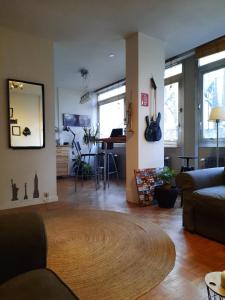 un soggiorno con divano e tavolo di St Catherine - Sweet home - Bxl - Studio Apartment with city view a Bruxelles