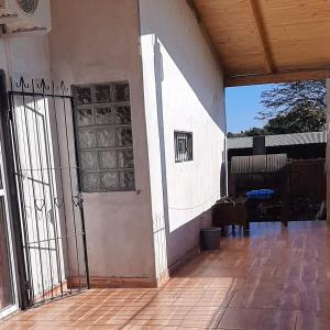 an outside view of a house with a door and a porch at Casa con piscina en Gobernador Roca in Gobernador Roca