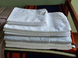 a pile of towels sitting on top of a bed at Appartamento Superior Condominio Orso Bianco, parquet, Wi-Fi in Prati di Tivo +60 photos