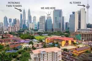 a city with skyscrapers and a city with buildings at Summer Suites Apartment @KLCC by Sarah's Lodge in Kuala Lumpur