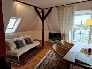 a living room with a couch and a tv at Ferienwohnung mit Flair in Dresden