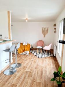 a living room with wooden floors and a bed at Le Petit Charmeur, parking, Wifi, gare in Flers