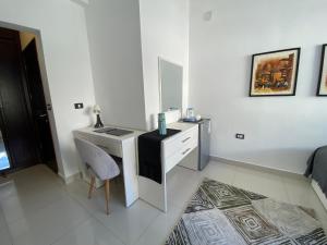 a white room with a desk and a mirror at Lemon Tree Residence in Amman +37 photos