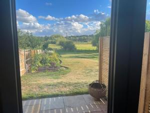 an open door with a view of a yard at Garden Studio in Newbury