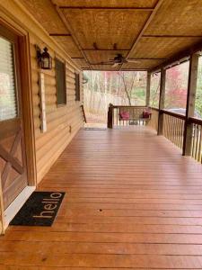 a porch of a cabin with a wooden floor at Hibernation Hideaway in Blairsville