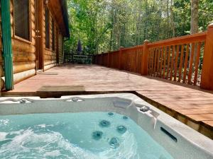 a hot tub on the deck of a cabin at Hibernation Hideaway in Blairsville