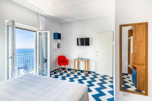 a bedroom with a view of the ocean at La Vigna di Bacco in Furore