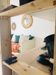 a room with a bed and a desk with a mirror at la daurade du frioul , île du Frioul, marseille in Marseille