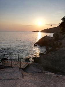 a sunset over a body of water with a dock at Amy Villa in Agnone