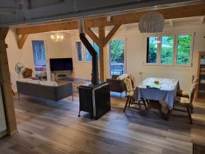 a living room with a wood stove and a table at Rhône Cottage 4 in Noville