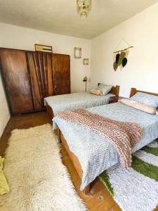 1 dormitorio con 2 camas y 2 alfombras en The Vintage House Zlatar, en Nova Varoš
