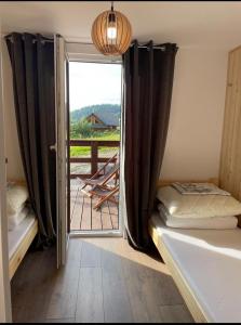 a bedroom with a door open to a balcony at RESET INN in Zawóz