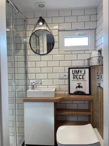 a bathroom with a sink and a toilet and a mirror at RESET INN in Zawóz