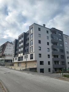 een groot wit gebouw aan de kant van een straat bij Bjelasnica MAGIC MOUNTAIN in Bjelašnica