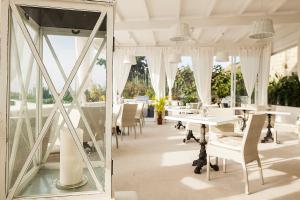 a mirror in a dining room with tables and chairs at Tenuta Del Poggio Antico in Ischia